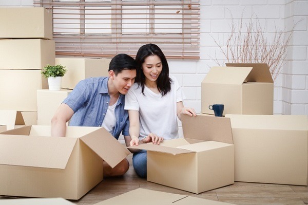 A couple unpacking boxes in their new home