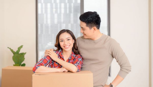 a young asian couple moving into a new home