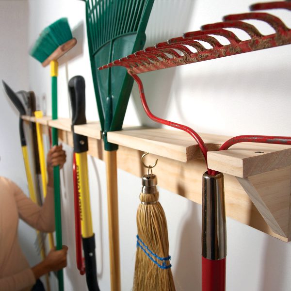 gardening tools hung on a wall wrack