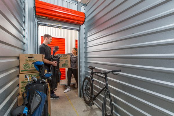 a young couple moving their belongings in a self storage unit